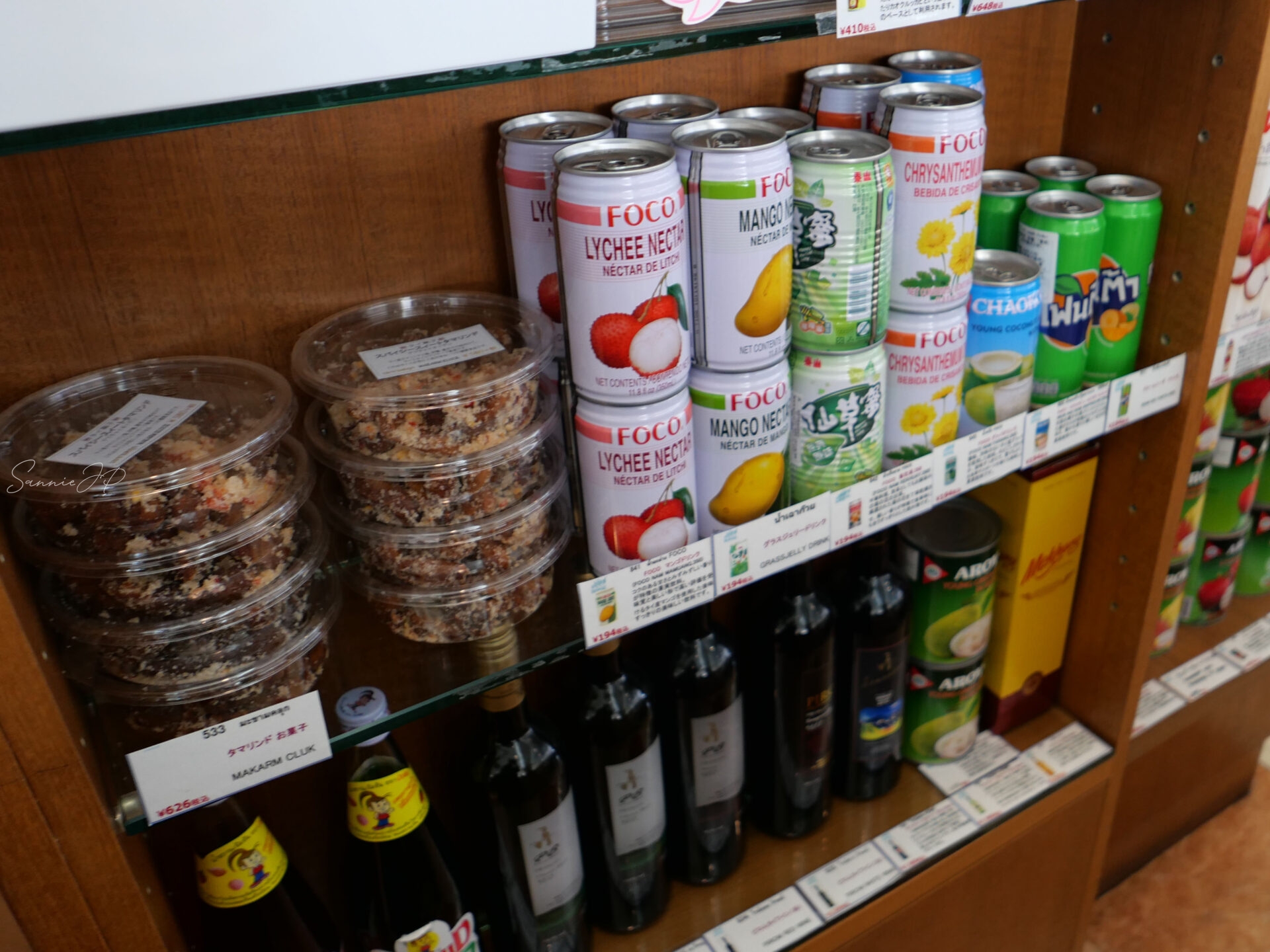 ゲウチャイ 新宿店のレジ周りに並ぶタイのドリンクや調味料